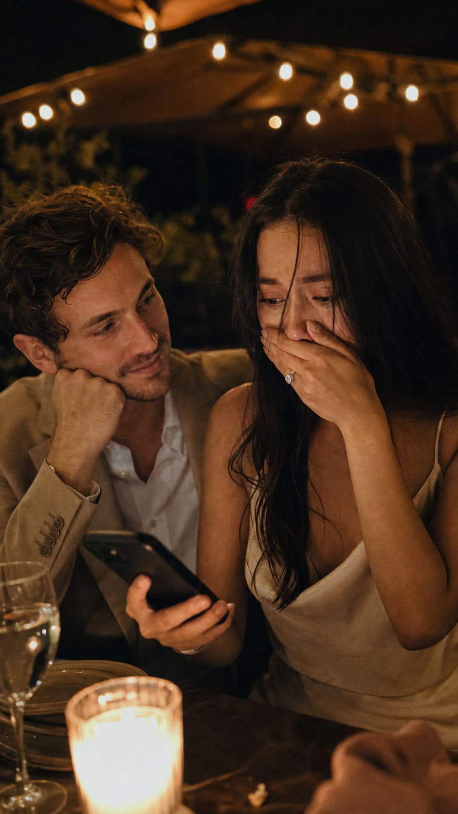 A just-engaged couple listening to the song he had written for the proposal